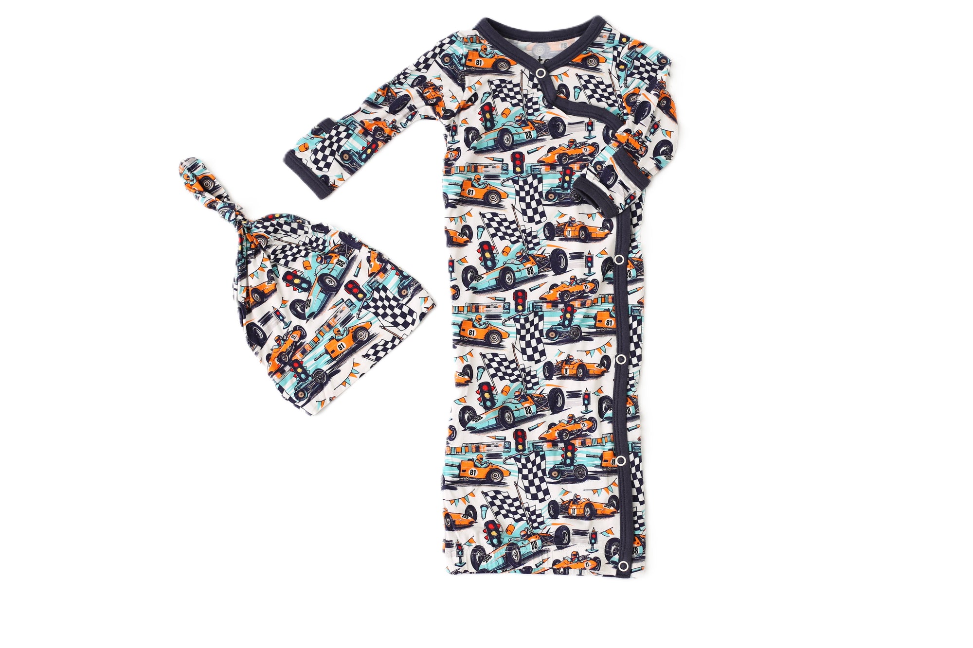 Children's outfit with long-sleeve shirt and hat featuring car and checkered pattern on a white background