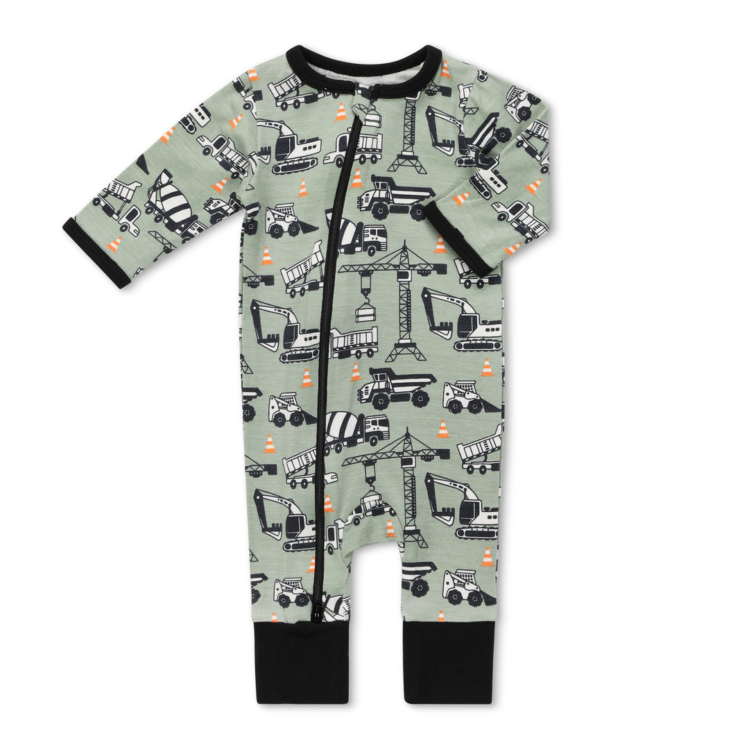 Baby onesie with construction vehicle pattern on a light green background