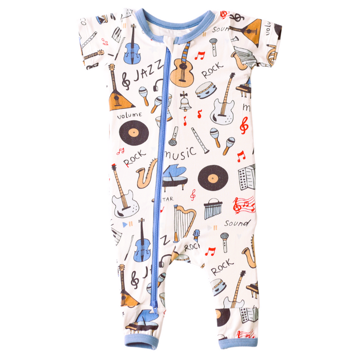 Children's onesie with musical instrument and word print on a white background
