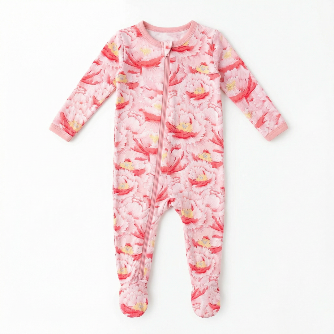 Pink flamingo patterned baby onesie on a white background