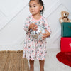 Child holding a disco ball in a room with a teddy bear and gift box in the background