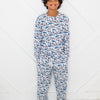 Child wearing a blue and white patterned pajama set on a white background