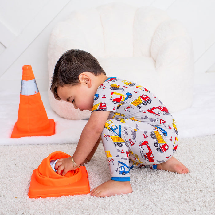 Child playing with toys on a white carpet