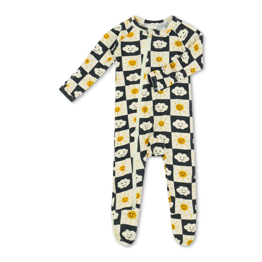 Children's onesie with a pattern of dogs, clouds, and suns on a white background