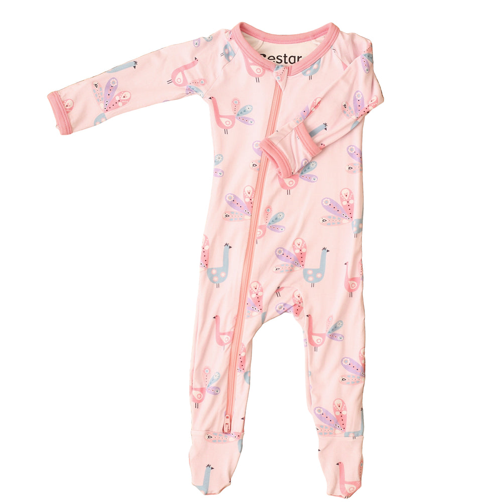 Pink baby onesie with animal pattern on a textured brown surface