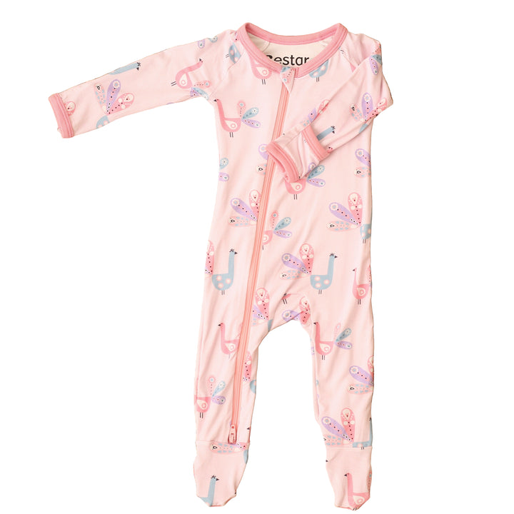Pink baby onesie with animal pattern on a textured brown surface