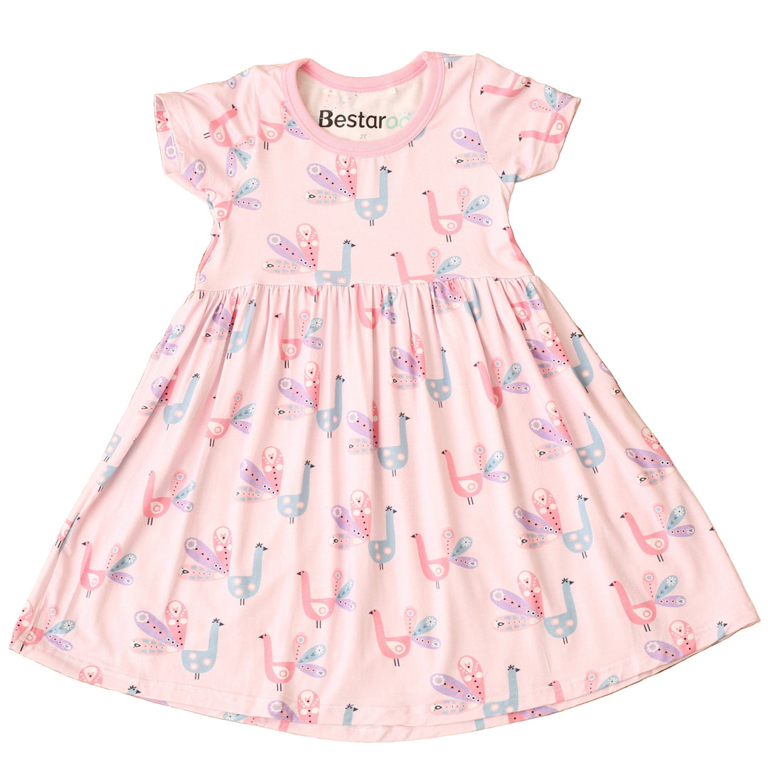 Pink dress with llama pattern on a textured brown surface