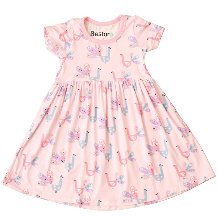 Pink dress with llama pattern on a textured brown surface