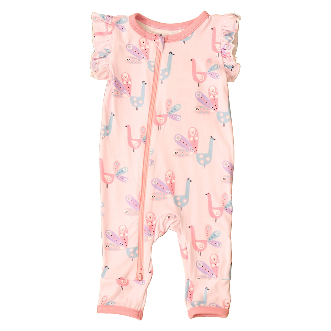 Baby romper with llama pattern on a textured brown surface