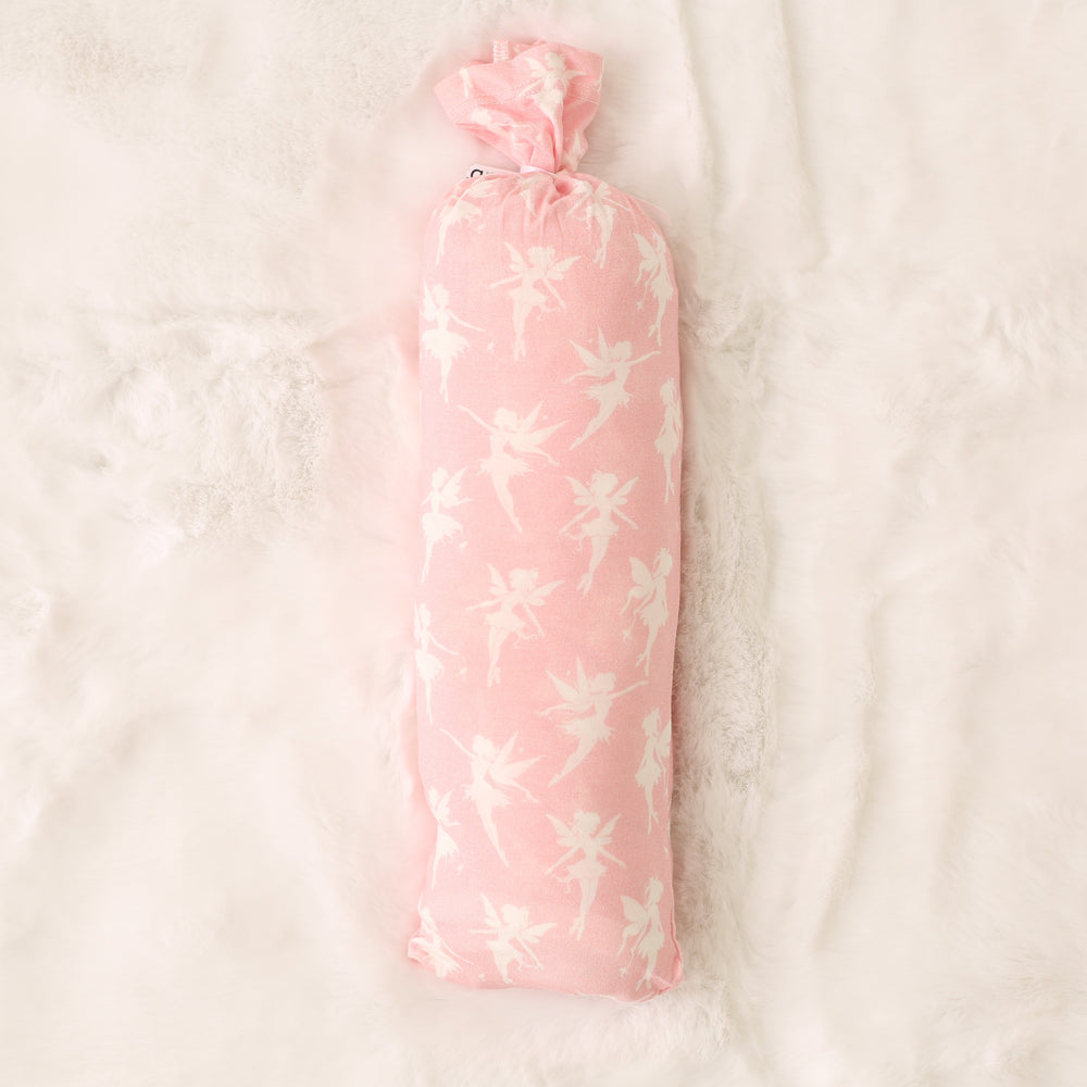 Pink floral-patterned bottle cover on a light beige background