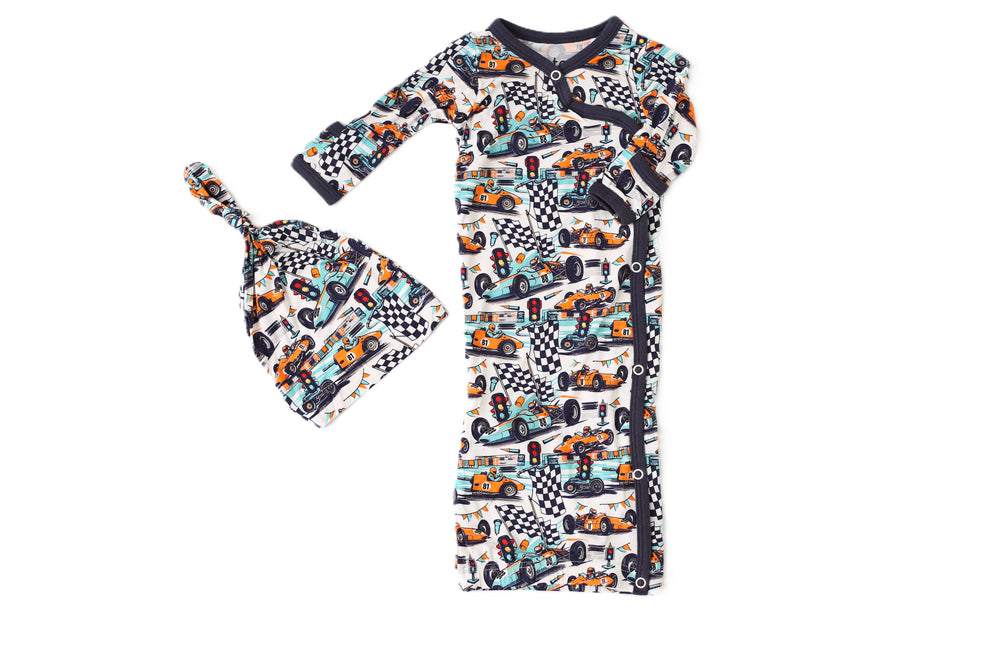 Children's outfit with long-sleeve shirt and hat featuring car and checkered pattern on a white background