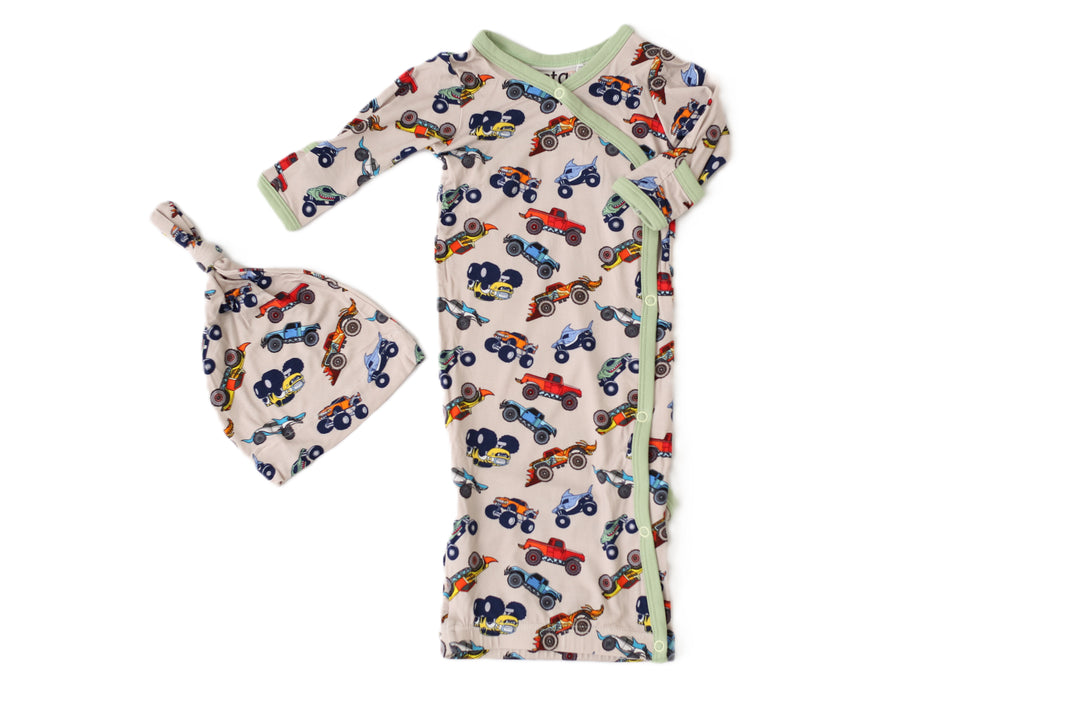 Baby outfit set with long-sleeve shirt and hat featuring car pattern on a white background