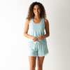 Woman wearing a light blue pajama set on a white background