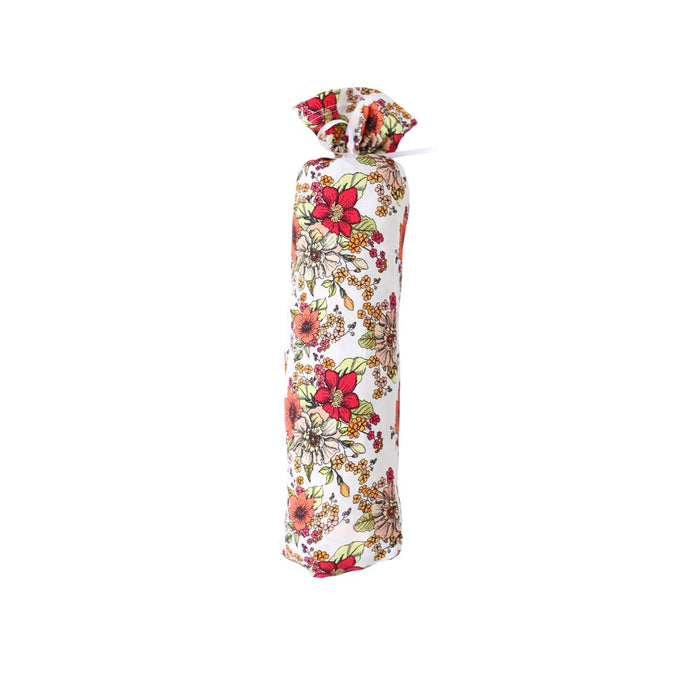 Floral-patterned bottle cover on a white background