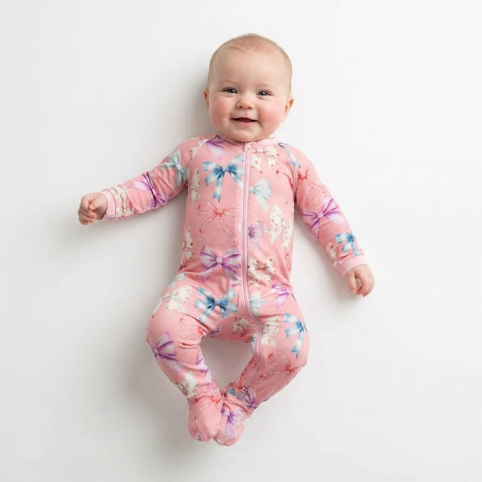 Baby wearing a pink floral onesie on a white background