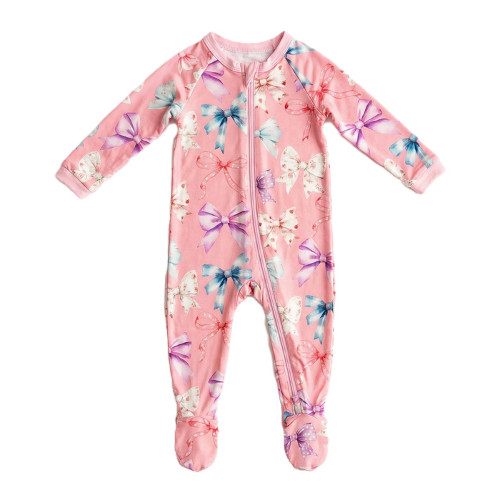 Pink baby onesie with floral and bow pattern on a white background