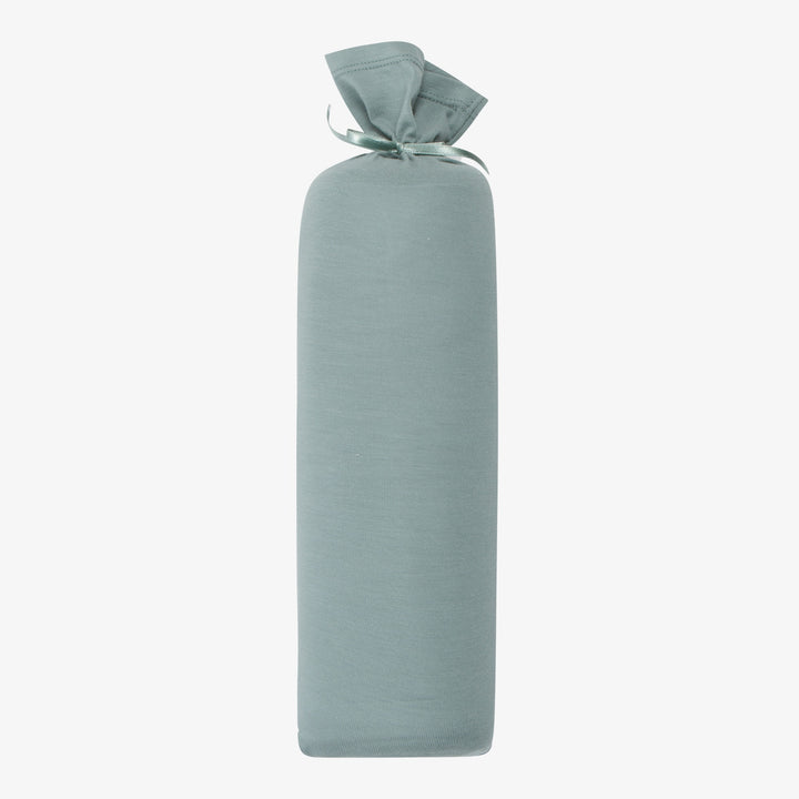 A rolled-up slate blue swaddle blanket with a tie at one end, displayed against a white background.